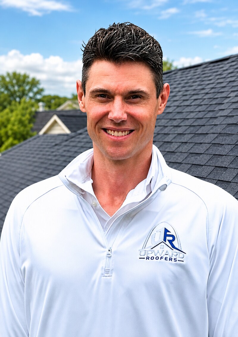Steven Ward, Owner of Upward Roofing, in a branded quarter-zip in front of a finished roof